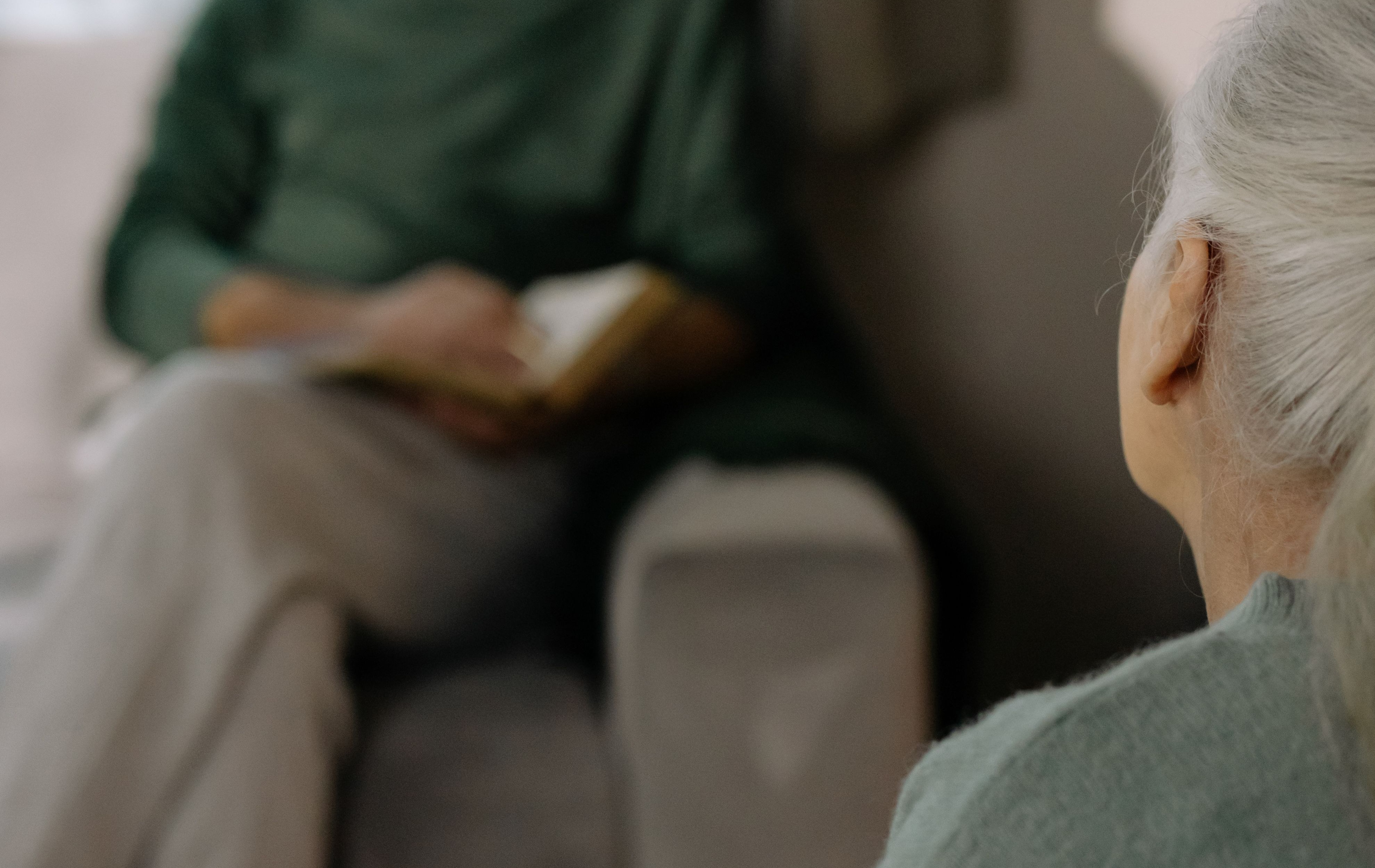 Adult support conversation in a calm, professional setting reflecting therapy and communication care.